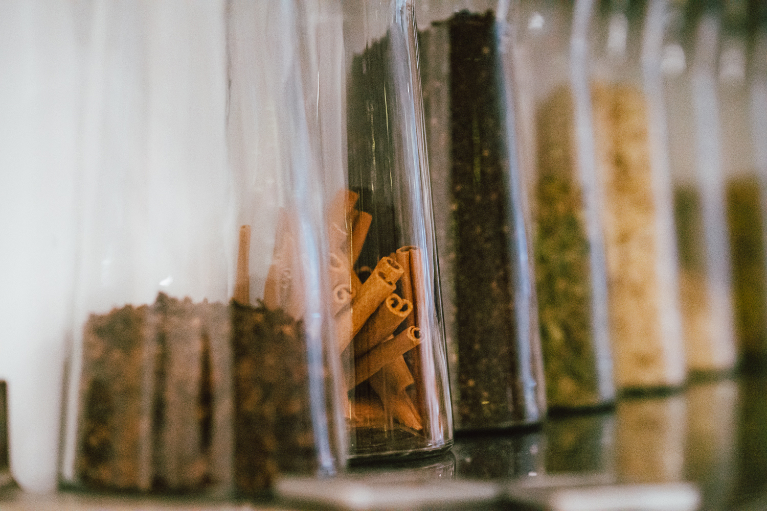 A row of glass containers hold a variety of spices at Botte Chai Bar in Saskatoon Saskatchewan.